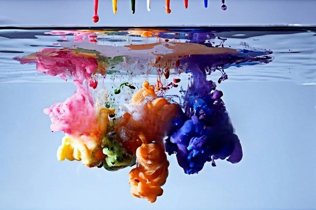 The picture shows a drop of multi-color pigment in water, the pigment in the water disperses, the scene of mingling . Color fastness and print durability are key indicators of dyeing and printing product quality.