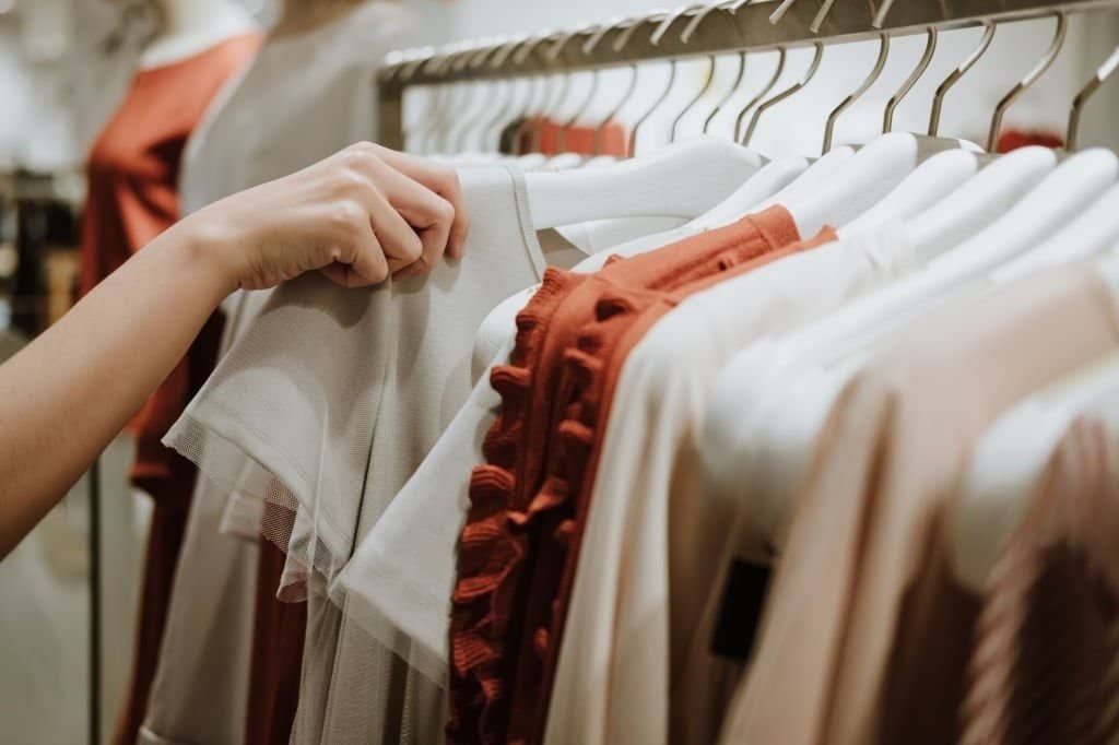 The picture shows customers picking out items in a plus size clothing store