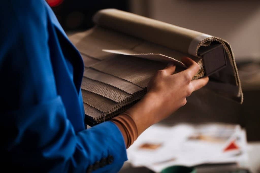 young woman going through material samples，understanding fabric handfeel