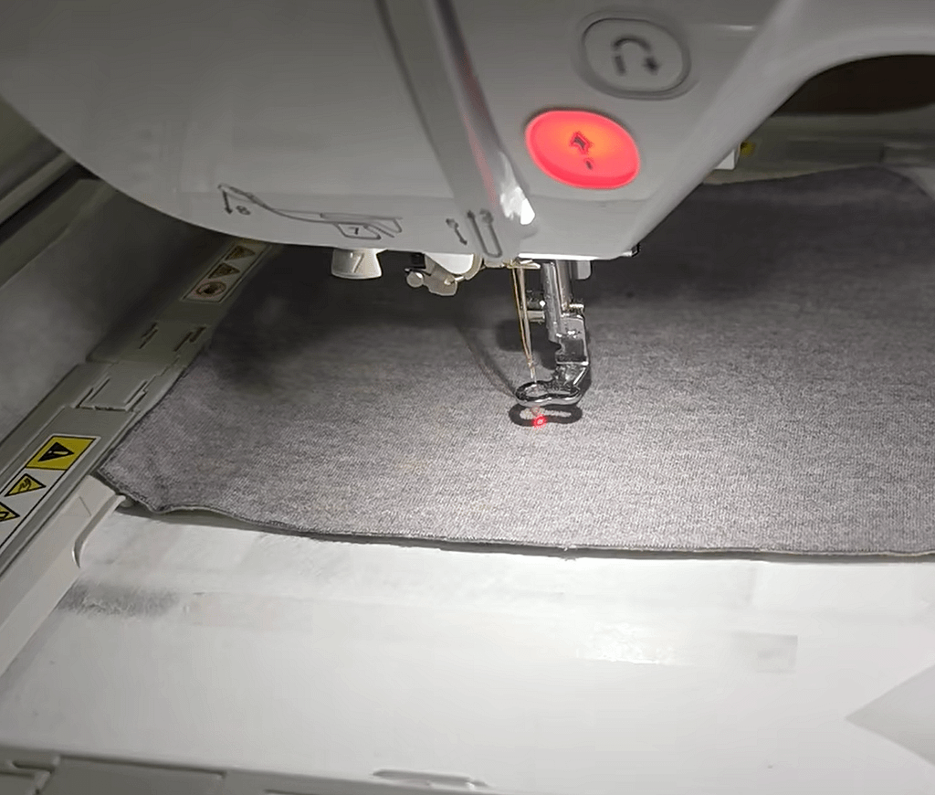 This is a sewing machine with laser alignment, using laser to precisely align the fabric.
