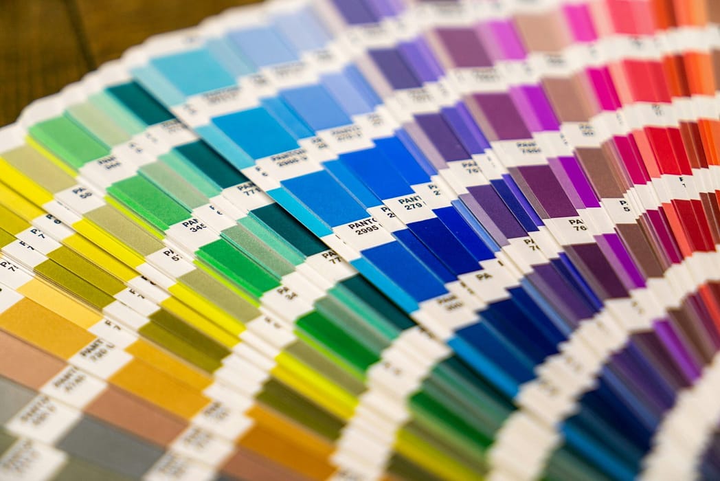 A fan - shaped color palette with various shades, representing color theory’s role in fashion design.