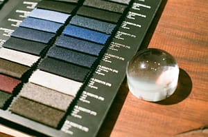 The staff is carefully looking at the color card to select the required fabric sourcing.
