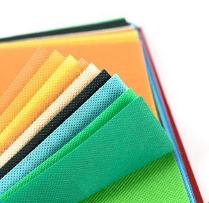 Polypropylene non-woven fabrics in different colors on the tabletop