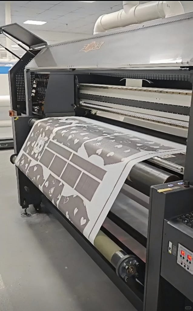 This is a detailed view of the operation of Dye Sublimation, a common garment printing technique.