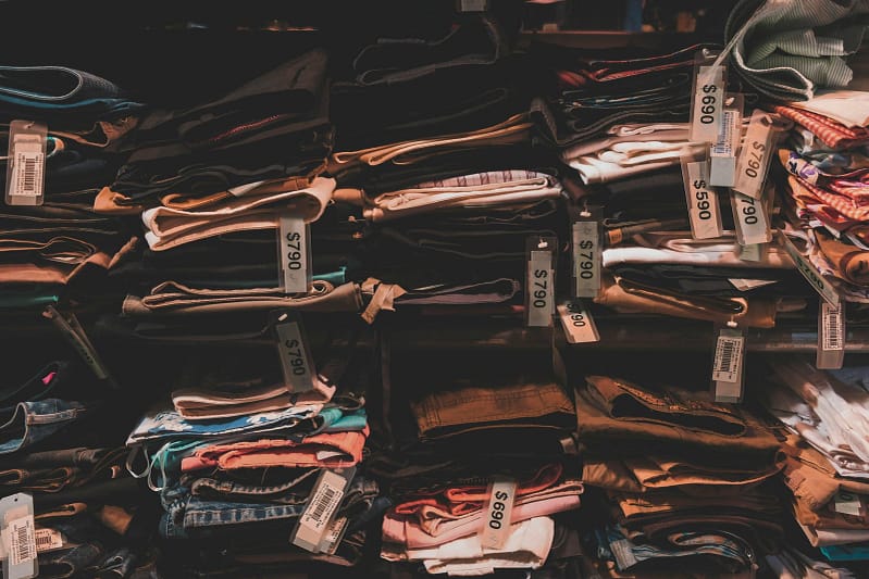 Here's a picture of a store with all kinds of pants piled up on top of each other.