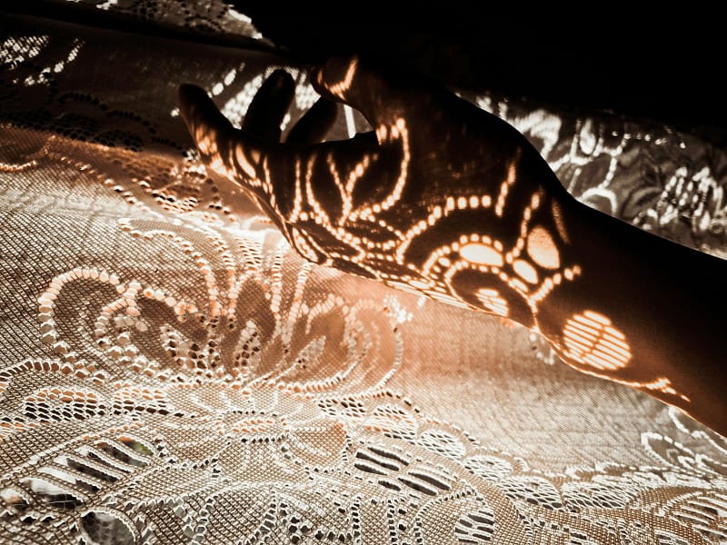 The sunlight shines on the lace fabric, reflecting beautiful patterns.